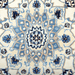 Cam Rugs: The center medallion of a cream base handmade Nain wool area rug, with accented blue details of floral motif designs.