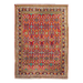 A red handmade Kashkoli wool area rug, with a traditional geometric motif design. 