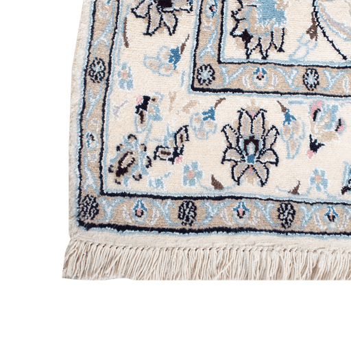Cam Rugs: A corner of a cream base handmade Nain wool area rug, with accented blue details of floral motif designs. 
