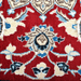 Cam Rugs: A detail of a cream base handmade Nain wool area rug, with accented red details of floral motif designs. 