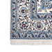 Cam Rugs: A close-up corner of a cream and blue Nain wool area rug, with a traditional floral motif design.