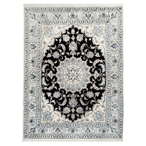 A cream and black handmade Nain wool area rug, with a traditional floral motif design. 