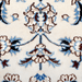 A close-up detail of a cream Nain wool area rug, with a traditional floral motif design.