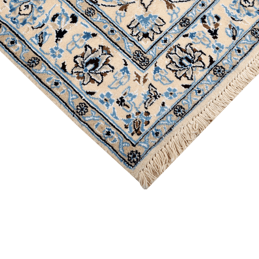 Cam Rugs: A corner of a cream base handmade Nain wool area rug, with details of floral motif designs.