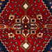 Cam Rugs: The center of a red handmade Kashkoli wool area rug, with a traditional geometric motif design. 