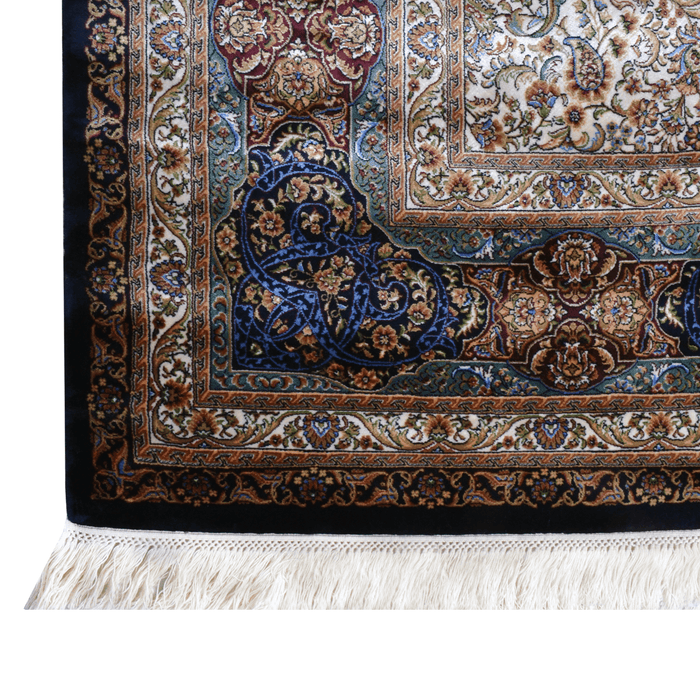 A corner of an Authentic Navy Modal Silk area rug with traditional floral motif designs.