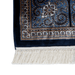 A corner of an Authentic Grey Modal Silk area rug with traditional floral motif designs.