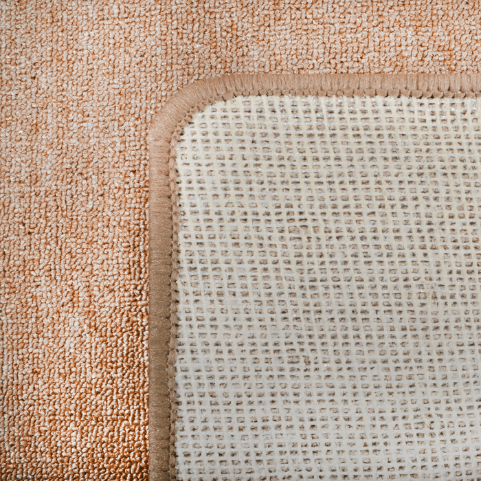 Cam Rugs: The back of a beige sample area rug.