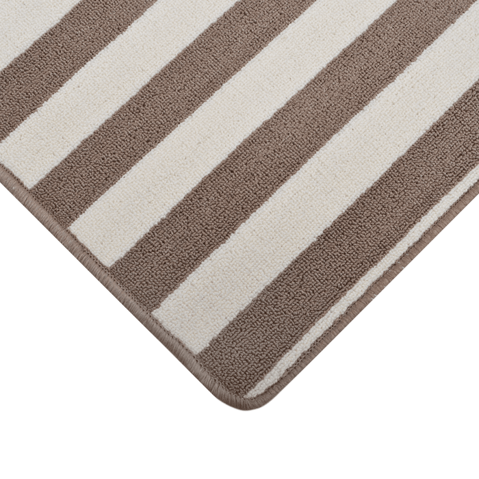 Cam Rugs: A close-up corner of a cream and beige sample area rug, with striped pattern.