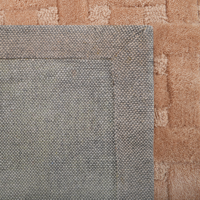 Cam Rugs: The back of a beige handmade sample area rug, with a basket weave design.