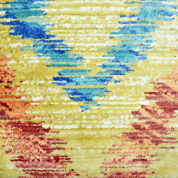 A detail of a yellow area rug with multi-coloured geometric diamond designs.