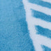 A close-up detail of a blue and white area rug with geometric designs.