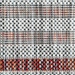 A detail of a red flat weave outdoor runner rug with striped designs.