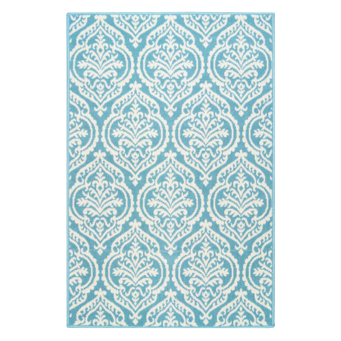 A green area rug, with floral damask designs.