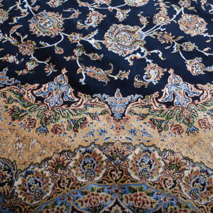 A detail of an Authentic Navy Modal Silk area rug with traditional floral motif designs.