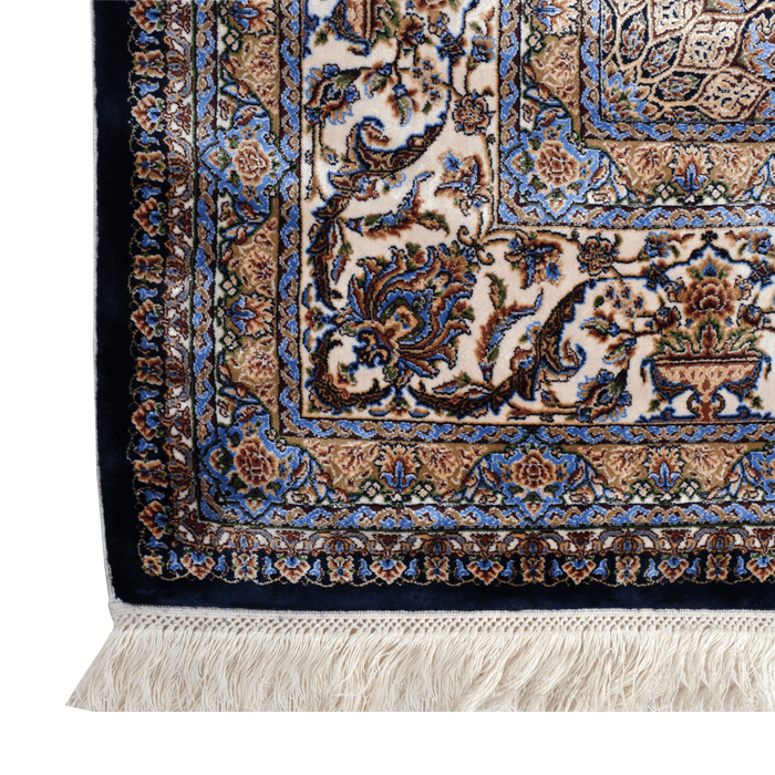 A corner of an Authentic Navy Modal Silk area rug with traditional floral motif designs.
