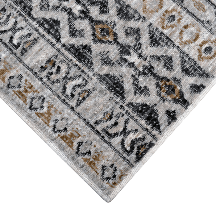 Corner of a CamRugs.Ca grey geometric area rug, made from recycled materials.