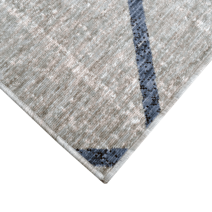 Corner of a CamRugs.Ca grey modern geometric area rug, made from recycled materials.