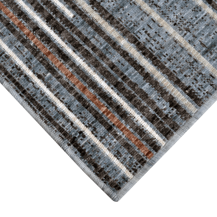 Corner of a CamRugs.Ca blue modern area rug, made from recycled materials.