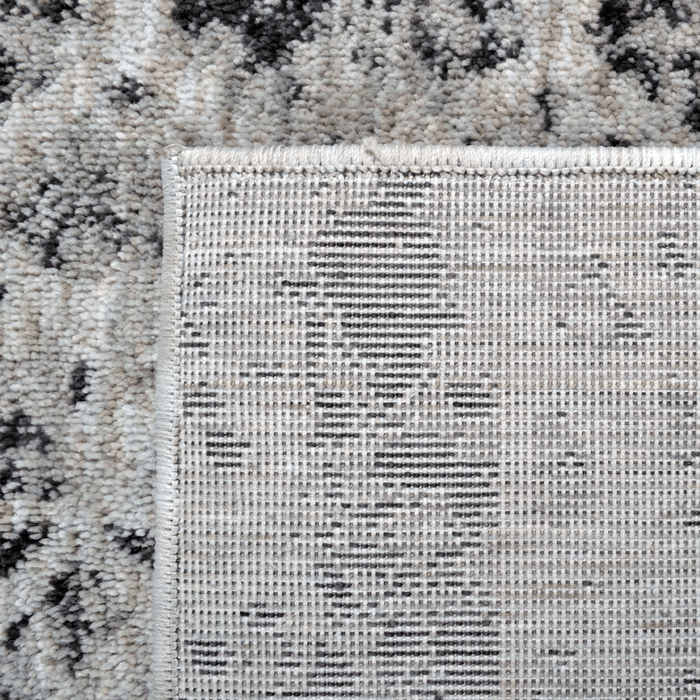 Back of a CamRugs.Ca grey geometric area rug, made from recycled materials.