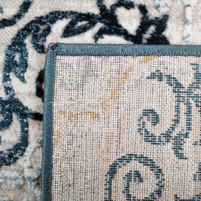 Back of a CamRugs.Ca cream and blue geometric traditional area rug.
