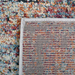 Back of a CamRugs.Ca multi-colour distressed geometric area rug.