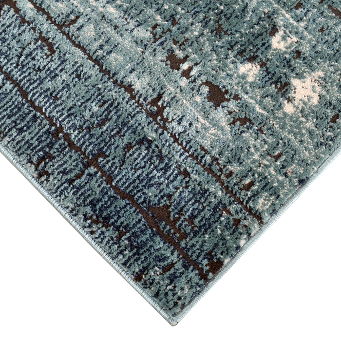 Corner of a CamRugs.Ca blue distressed abstract area rug.