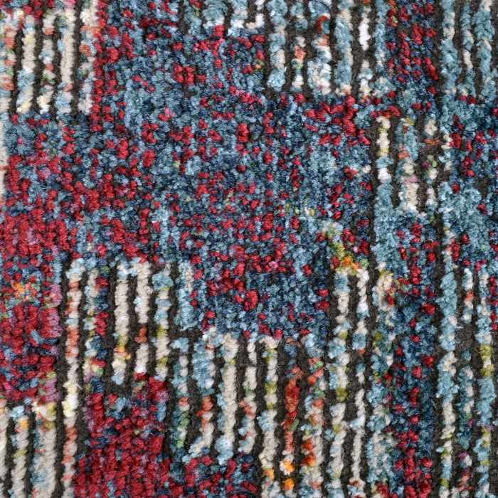 Detail of a CamRugs.Ca multi-colour distressed abstract area rug.