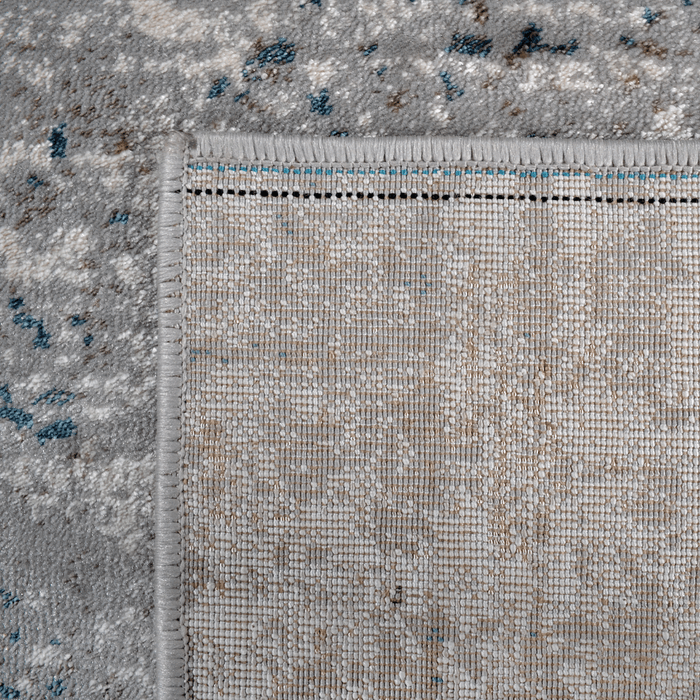 Back of a CamRugs.Ca grey distressed area rug.