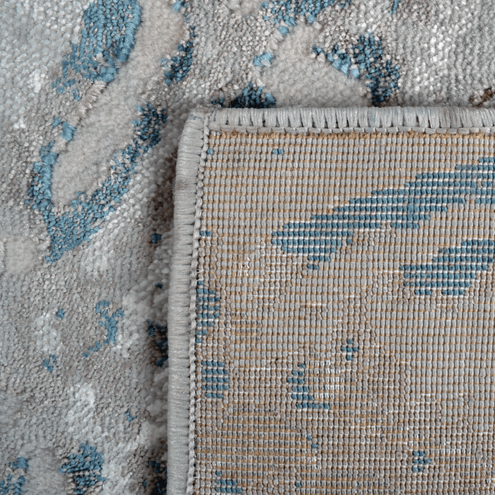 Back of a CamRugs.Ca grey distressed geometric area rug.