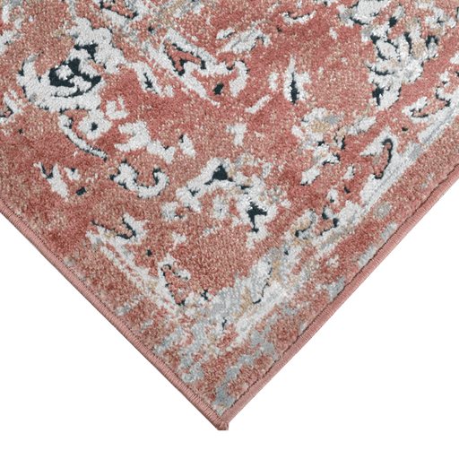 Corner of a CamRugs red distressed traditional area rug.