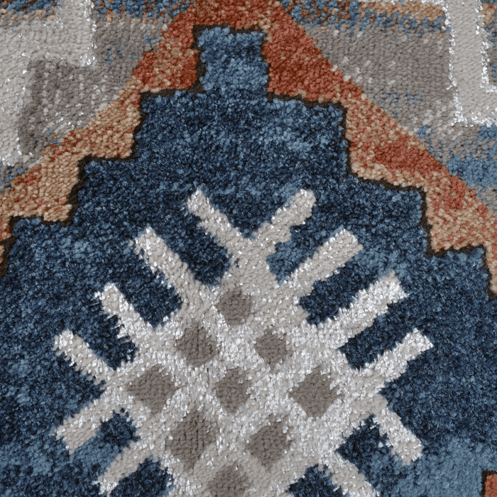 Detail of a CamRugs blue geometric area rug.