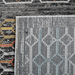 Back of a CamRugs black and multi-colour geometric area rug.
