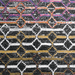 Detail of a CamRugs black and multi-colour geometric area rug.