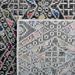 Back of a CamRugs black and multi-colour geometric area rug.