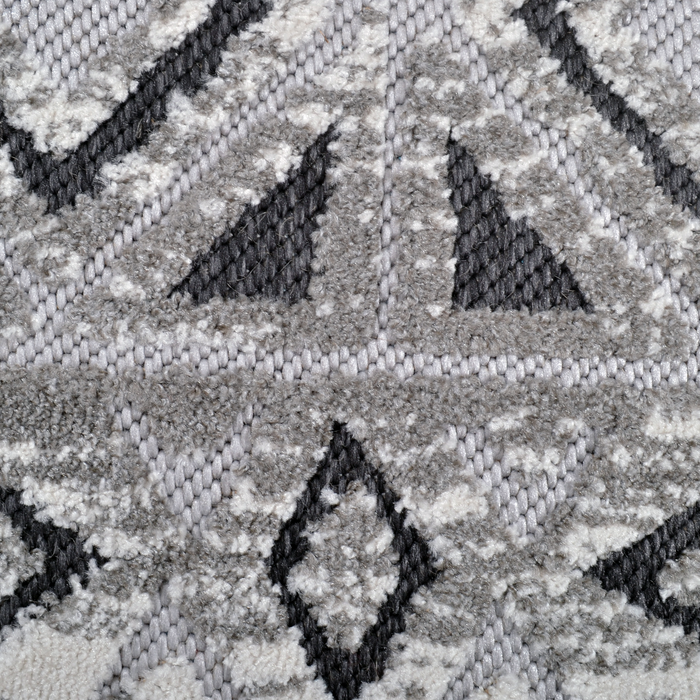 Detail of a CamRugs grey geometric area rug.