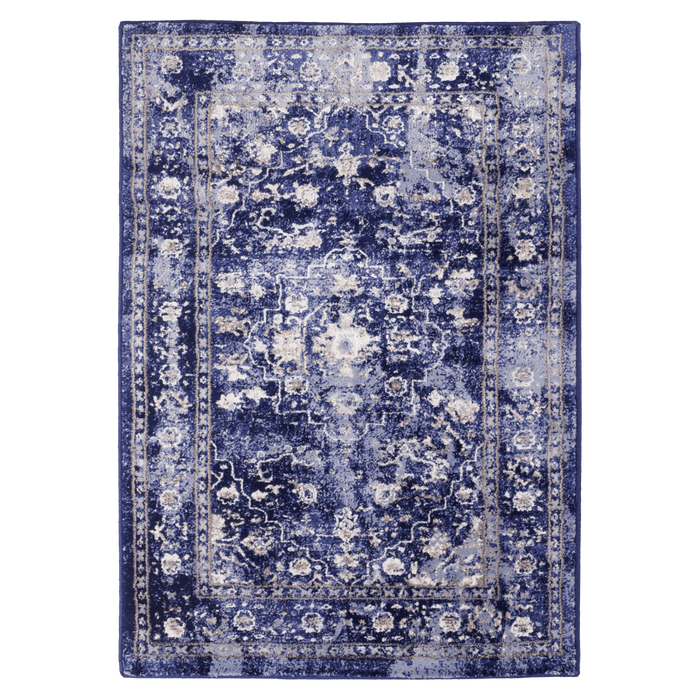 A purple textured area rug with distressed traditional floral designs.