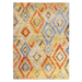 A yellow area rug with multi-coloured geometric diamond designs.