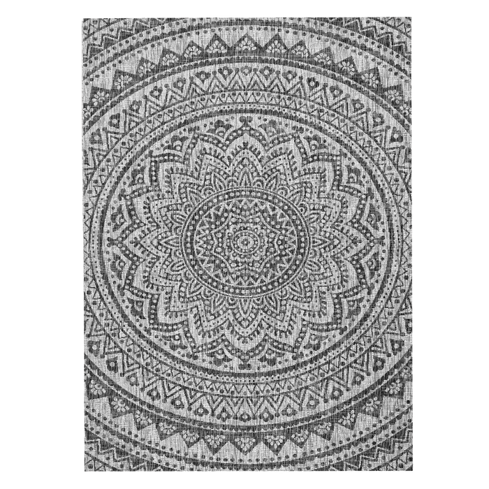 A black and grey flat weave outdoor rug with floral motif designs.