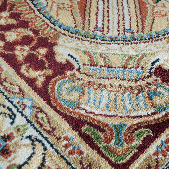A detail of an Authentic Red Modal Silk area rug with traditional floral motif designs.