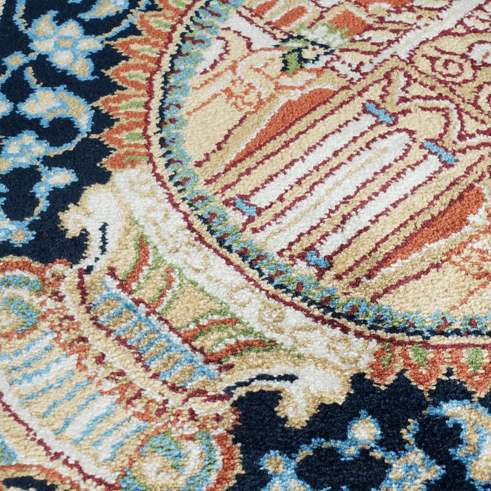 A detail of an Authentic Blue Modal Silk area rug with traditional floral motif designs.