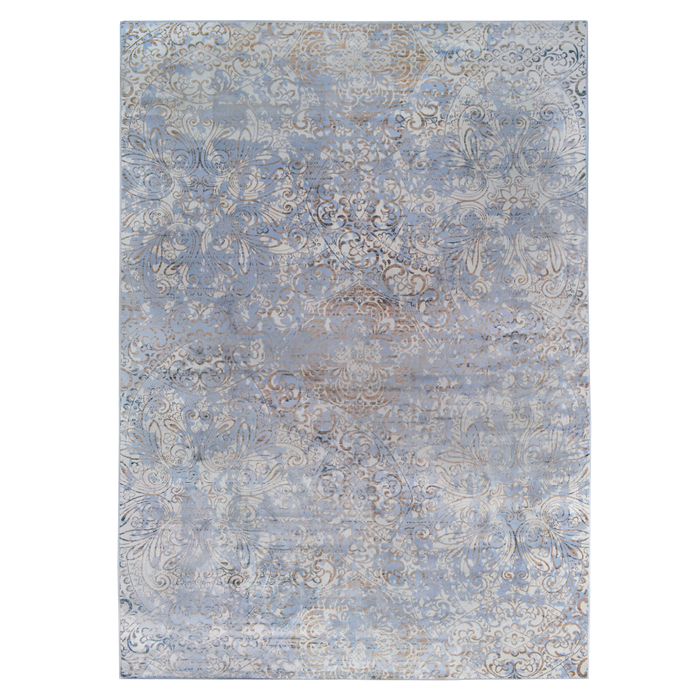 A blue area rug with distressed traditional floral motif designs.