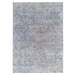 A blue area rug with distressed traditional floral motif designs.