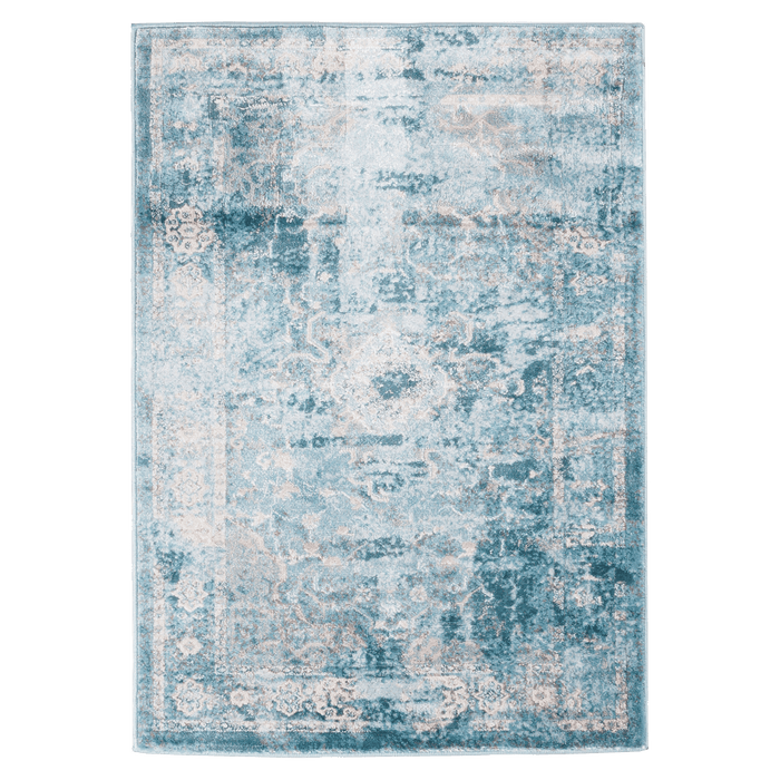A blue textured area rug with distressed traditional floral motif designs.