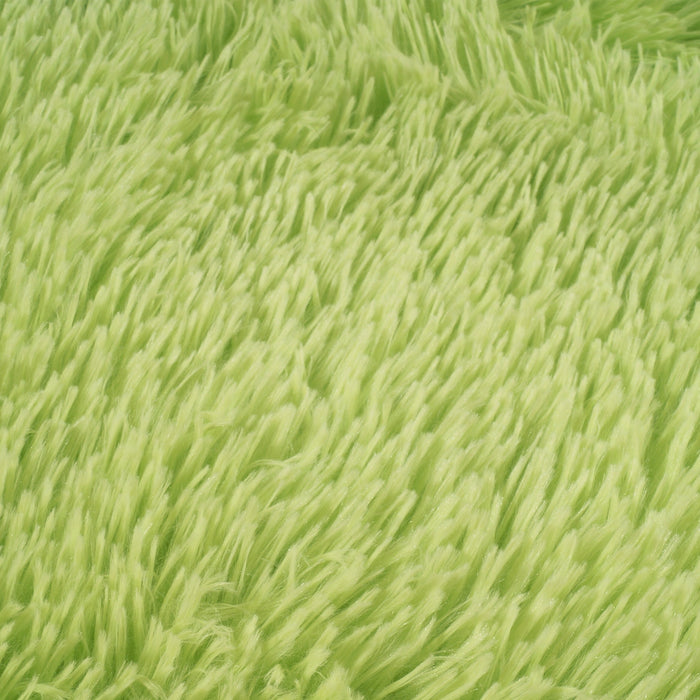 A detail of a solid lime shag area rug.