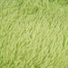 A detail of a solid lime shag area rug.