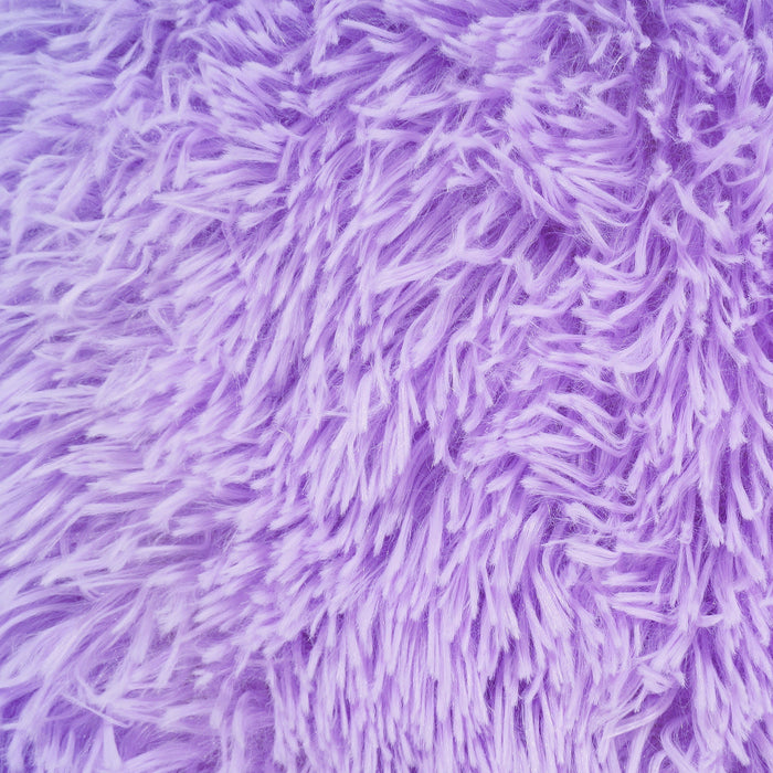 A detail of a solid lilac shag area rug.