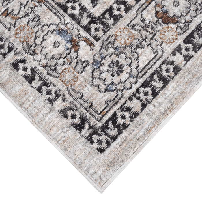 Corner of a CamRugs.Ca ivory traditional area rug, made from recycled materials.