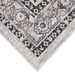 Corner of a CamRugs.Ca ivory traditional area rug, made from recycled materials.